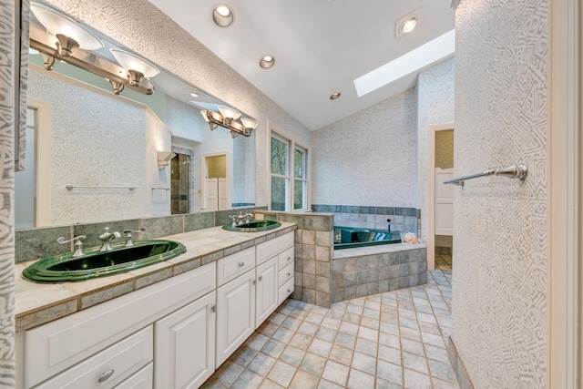 3649 Peakwood Dr SW, Roanoke, VA 24014 - bathroom with vaulted ceiling, a bath, double vanity, a skylight, and recessed lighting