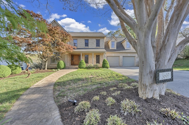 3649 Peakwood Dr SW, Roanoke, VA 24014 - view of front facade with concrete driveway, a porch, brick siding, an attached garage, and a front lawn