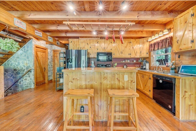 kitchen with black appliances, wooden ceiling, a kitchen island, and light wood-type flooring