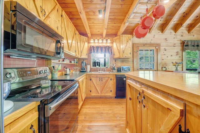 kitchen with a sink, black appliances, beamed ceiling, light wood-style flooring, and wooden ceiling