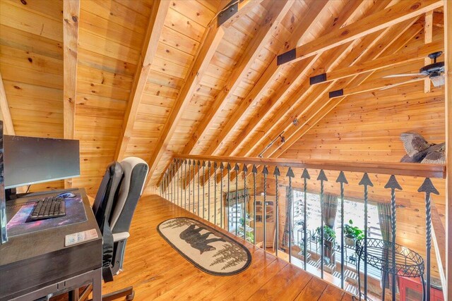 office with wood ceiling, wood finished floors, vaulted ceiling with beams, and wooden walls