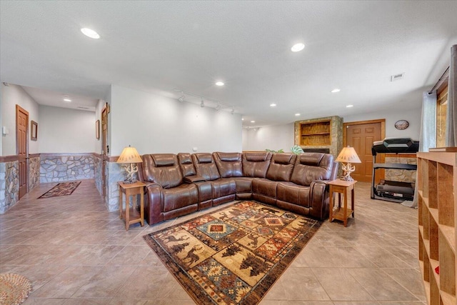 living area with recessed lighting, visible vents, a wainscoted wall, and light tile patterned floors