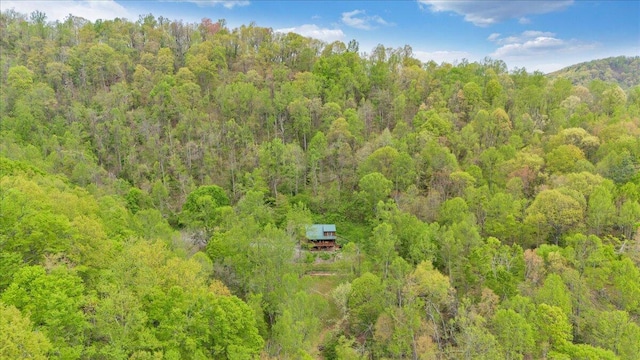 birds eye view of property with a view of trees