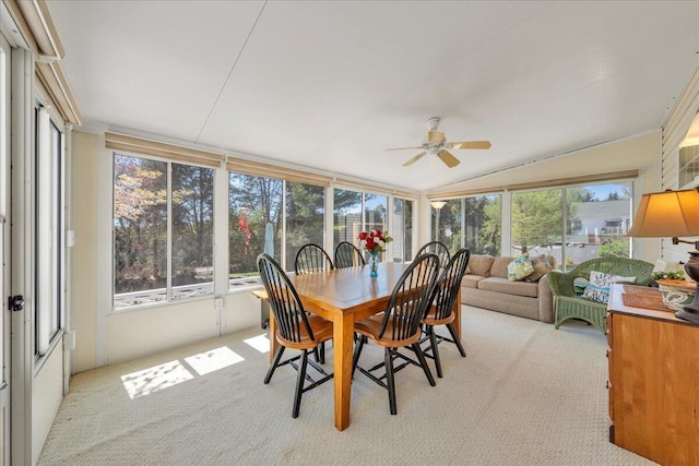 sunroom / solarium featuring a wealth of natural light, lofted ceiling, and carpet