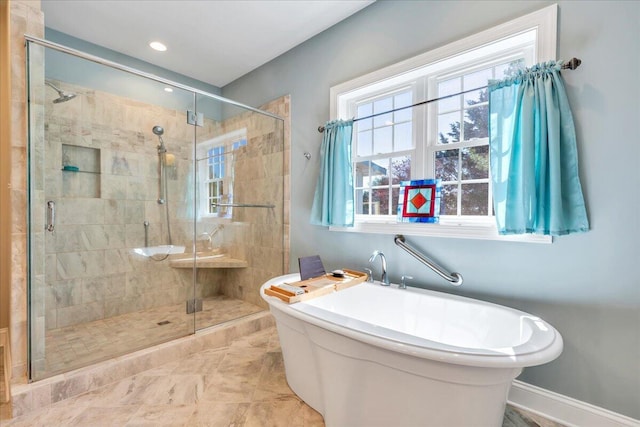 bathroom featuring recessed lighting, baseboards, a freestanding tub, and a stall shower