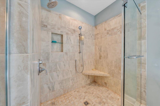 bathroom with tiled shower