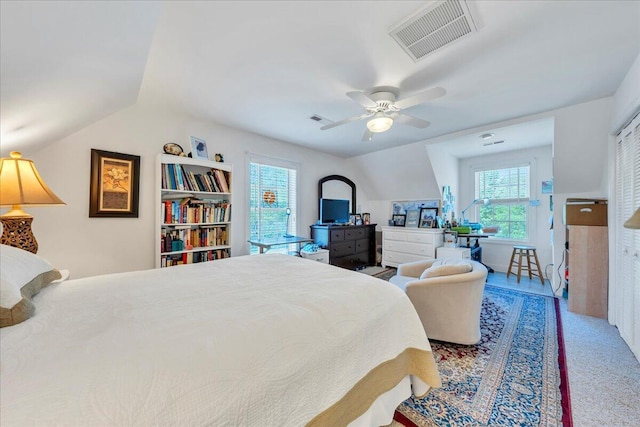 bedroom featuring a ceiling fan, visible vents, and carpet