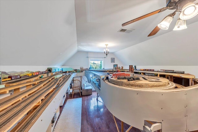 interior space featuring ceiling fan, lofted ceiling, wood finished floors, and visible vents