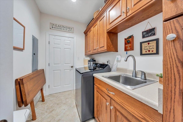 clothes washing area with electric panel, washer and dryer, a sink, and cabinet space