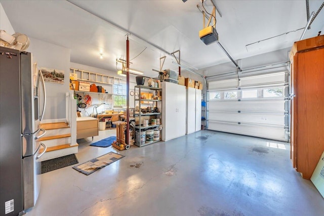 garage featuring stainless steel fridge and a garage door opener