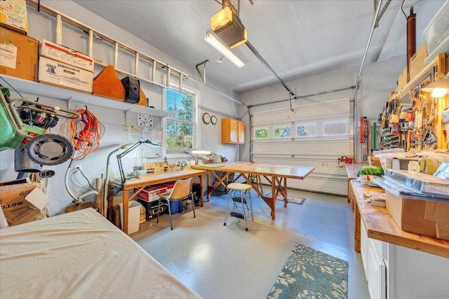 garage with a workshop area and a garage door opener