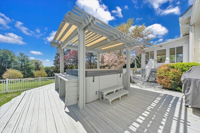 deck with a pergola and a hot tub