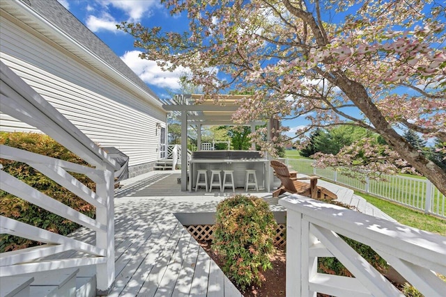 deck with a pergola, a hot tub, and fence