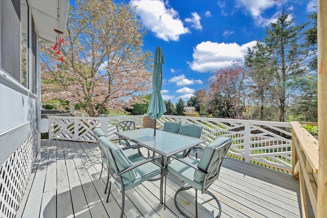 wooden terrace featuring outdoor dining area