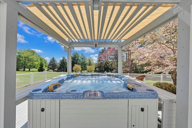view of pool with a hot tub and fence