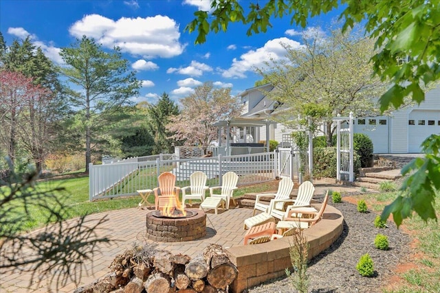 view of patio featuring an outdoor fire pit and fence