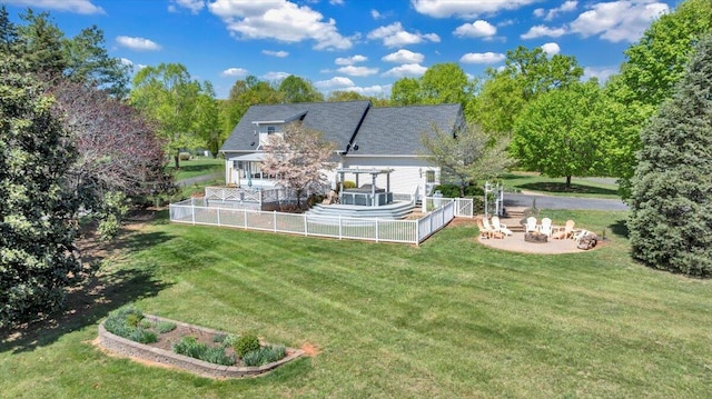 back of property with fence, a pergola, a fire pit, and a yard