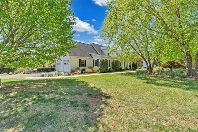 view of yard with driveway and a garage