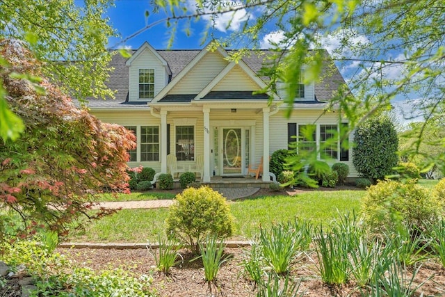 new england style home with roof with shingles