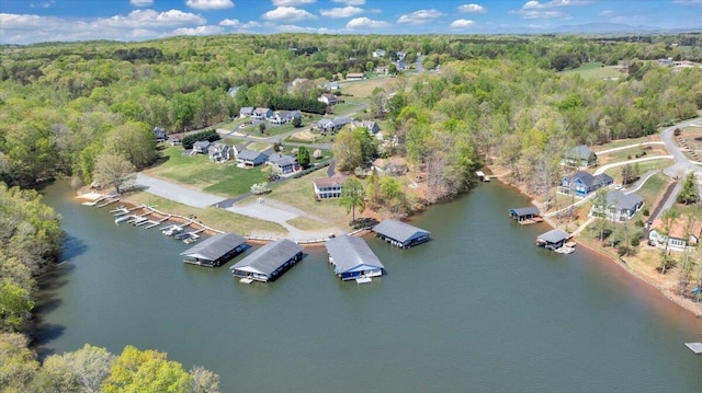 birds eye view of property with a view of trees and a water view