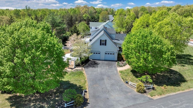 birds eye view of property featuring a view of trees