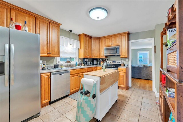 1944 Burma Rd, Salem, VA 24153 - kitchen with stainless steel appliances, plenty of natural light, light tile patterned floors, and pendant lighting