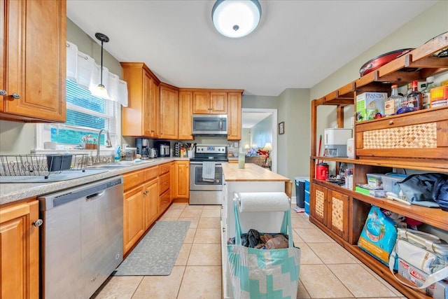 1944 Burma Rd, Salem, VA 24153 - kitchen with a sink, light tile patterned floors, light countertops, and appliances with stainless steel finishes