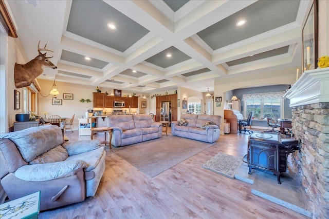 398 River Ridge Rd SE, Copper Hill, VA 24079 - living room with light wood finished floors, a wood stove, coffered ceiling, beam ceiling, and ornamental molding