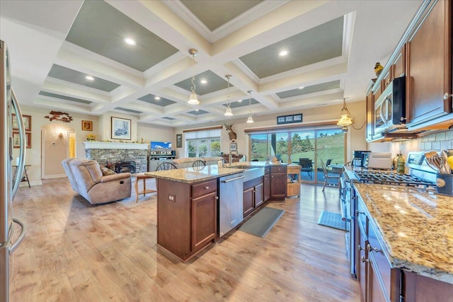 398 River Ridge Rd SE, Copper Hill, VA 24079 - kitchen with stainless steel appliances, open floor plan, beamed ceiling, a fireplace, and light stone countertops