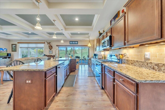 398 River Ridge Rd SE, Copper Hill, VA 24079 - kitchen featuring appliances with stainless steel finishes, a kitchen breakfast bar, light wood finished floors, beamed ceiling, and light stone countertops
