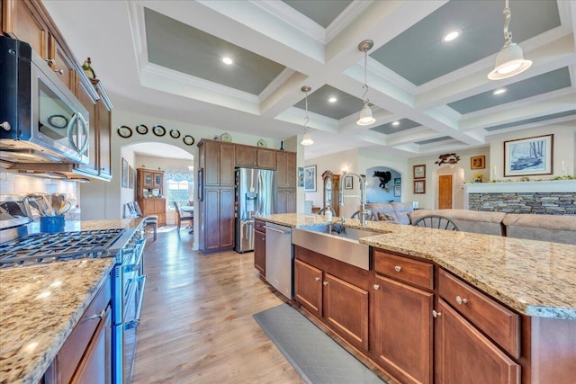 398 River Ridge Rd SE, Copper Hill, VA 24079 - kitchen with arched walkways, stainless steel appliances, light wood finished floors, coffered ceiling, and hanging light fixtures