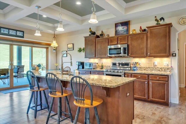 398 River Ridge Rd SE, Copper Hill, VA 24079 - kitchen featuring appliances with stainless steel finishes, coffered ceiling, tasteful backsplash, light wood-type flooring, and a kitchen bar