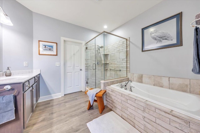 398 River Ridge Rd SE, Copper Hill, VA 24079 - bathroom with a stall shower, a bath, wood finished floors, vanity, and baseboards