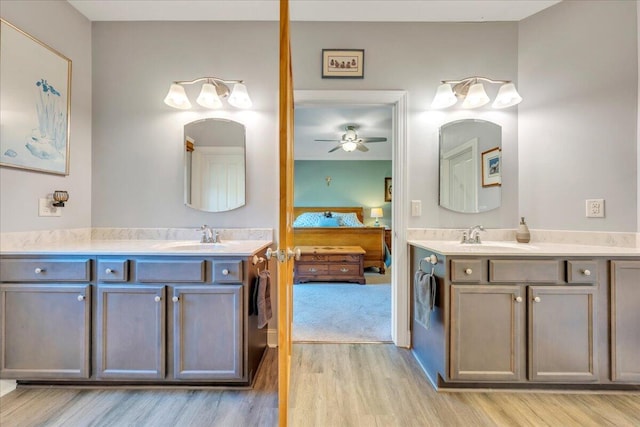 398 River Ridge Rd SE, Copper Hill, VA 24079 - ensuite bathroom featuring wood finished floors, a ceiling fan, and two vanities