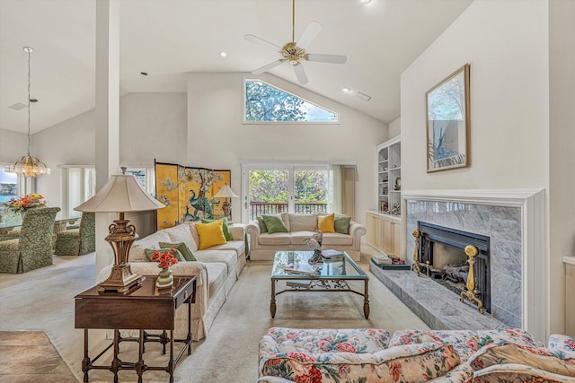 living room featuring high vaulted ceiling, a high end fireplace, ceiling fan, carpet, and recessed lighting