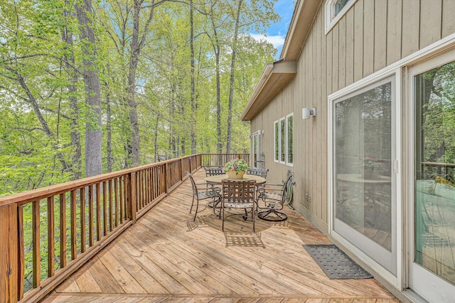 wooden terrace with outdoor dining space