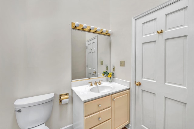 half bath with vanity and toilet