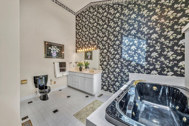 full bath with wallpapered walls, tile patterned floors, vanity, a tub with jets, and baseboards