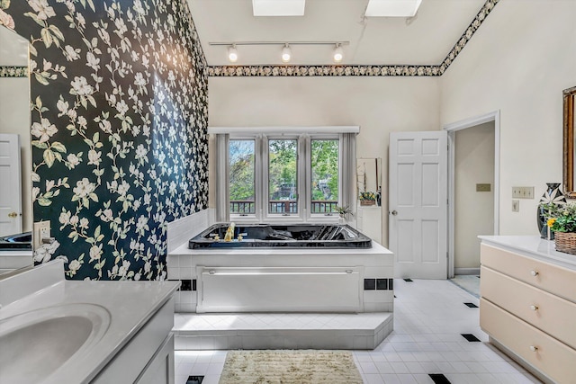 full bathroom featuring wallpapered walls, tile patterned flooring, track lighting, vanity, and a bath