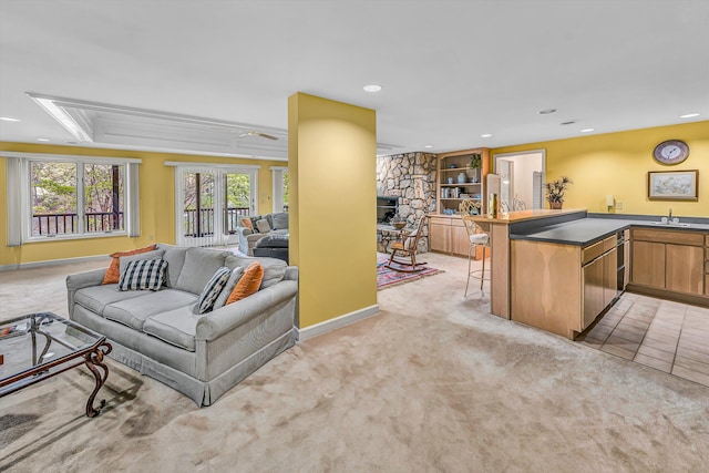 living area with recessed lighting, baseboards, and light carpet