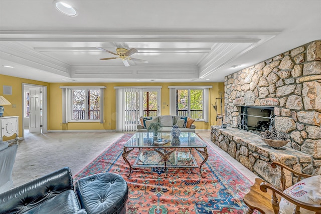 living room featuring ceiling fan, carpet floors, crown molding, and a tray ceiling