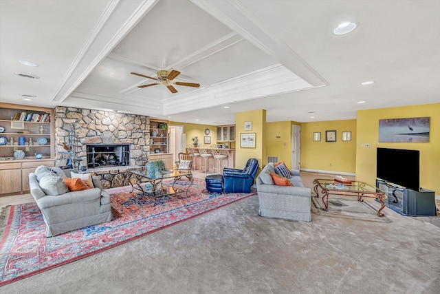 carpeted living area with recessed lighting, coffered ceiling, a ceiling fan, crown molding, and a fireplace