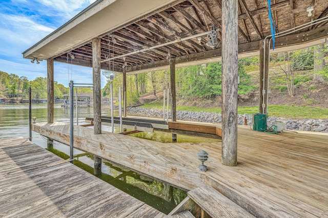 view of dock with boat lift and a water view