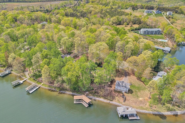aerial view featuring a forest view and a water view