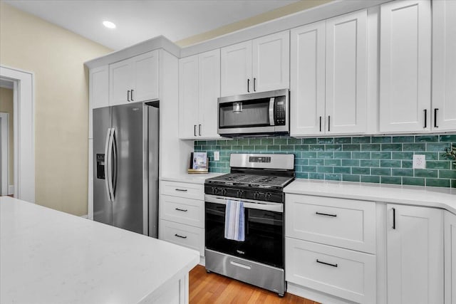 2219 Carter Rd SW, Roanoke, VA 24015 - kitchen with appliances with stainless steel finishes, light countertops, decorative backsplash, and recessed lighting