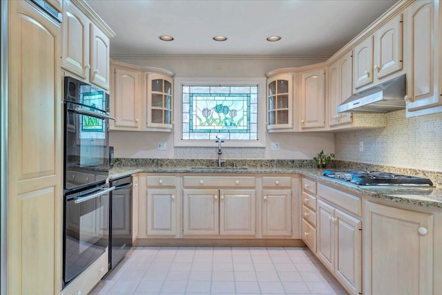 5241 N Spring Dr, Roanoke, VA 24019 - kitchen with a sink, stainless steel gas stovetop, under cabinet range hood, glass insert cabinets, and light stone counters