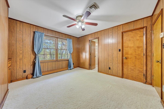 5241 N Spring Dr, Roanoke, VA 24019 - spare room featuring carpet, ceiling fan, wood walls, and baseboards