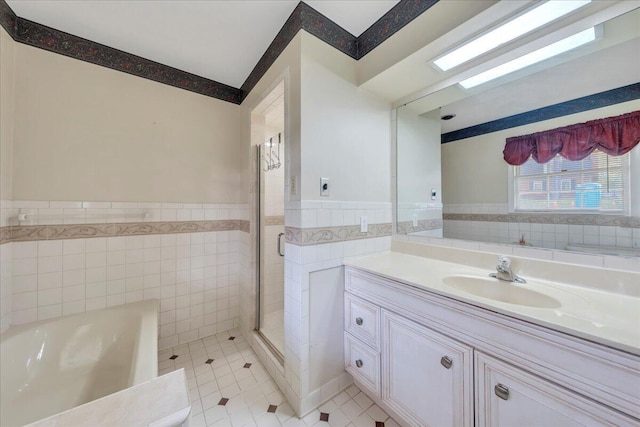 5241 N Spring Dr, Roanoke, VA 24019 - full bath with tile walls, tile patterned flooring, wainscoting, vanity, and a garden tub