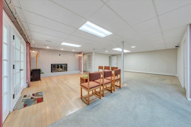 5241 N Spring Dr, Roanoke, VA 24019 - living room with wood finished floors, a fireplace, a paneled ceiling, and baseboards