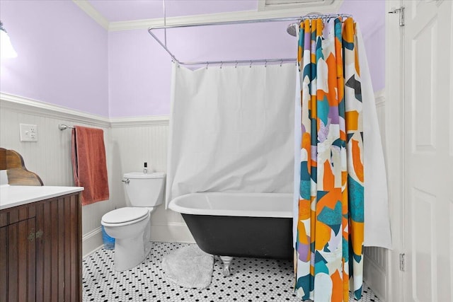bathroom with a wainscoted wall, toilet, vanity, and crown molding